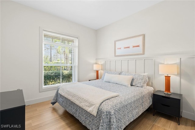 bedroom featuring baseboards and wood finished floors