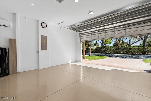 garage featuring electric panel, recessed lighting, and a wall unit AC