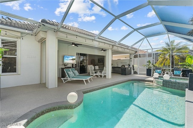 view of swimming pool featuring a patio, a ceiling fan, a pool with connected hot tub, and a lanai