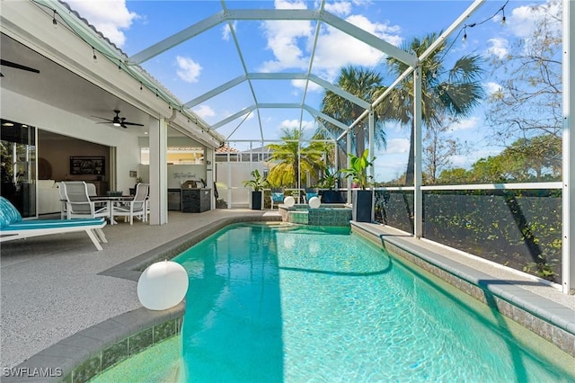 view of pool featuring glass enclosure, a patio, ceiling fan, and a pool with connected hot tub