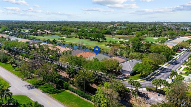 drone / aerial view with view of golf course and a water view