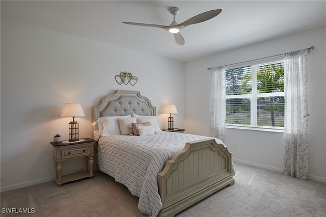 bedroom featuring light carpet, ceiling fan, and baseboards