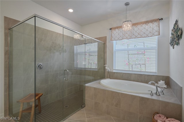 full bathroom featuring a stall shower, a garden tub, and tile patterned floors