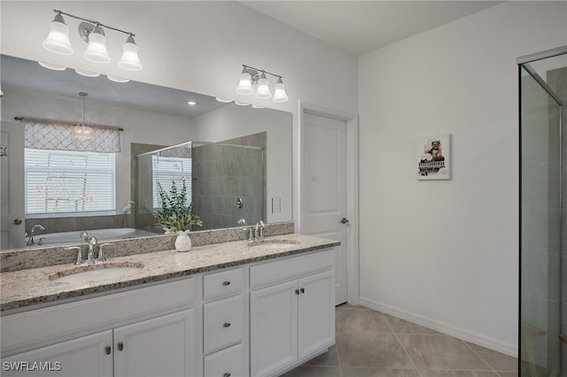 full bathroom with a stall shower, tile patterned flooring, a sink, and double vanity