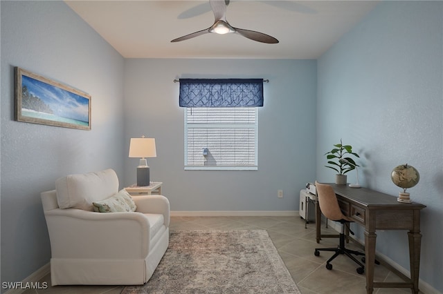 office area with ceiling fan, baseboards, and light tile patterned flooring