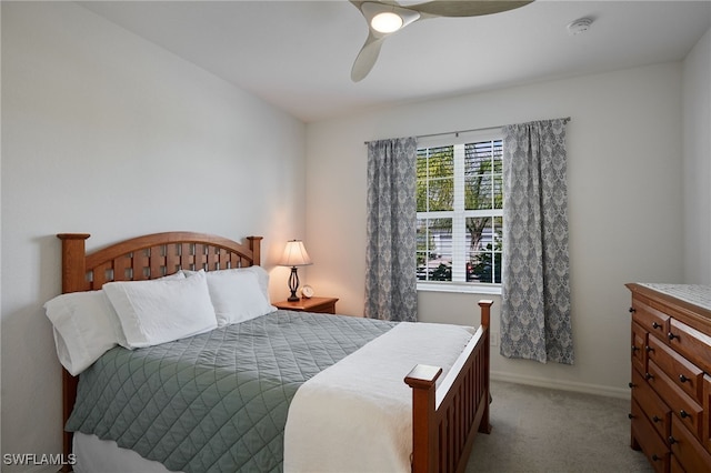 carpeted bedroom with baseboards and a ceiling fan