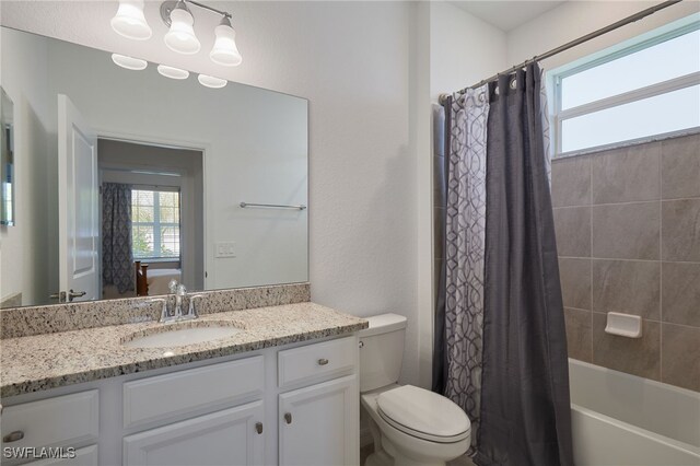 full bath with shower / bathtub combination with curtain, ensuite bath, vanity, and toilet