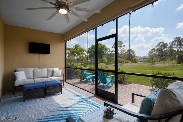 sunroom featuring a ceiling fan