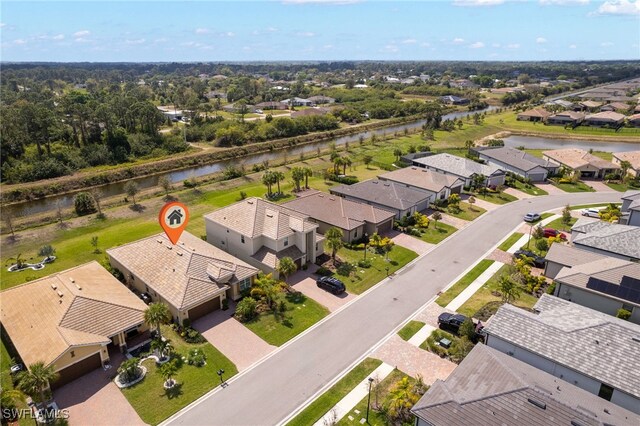 birds eye view of property with a residential view and a water view