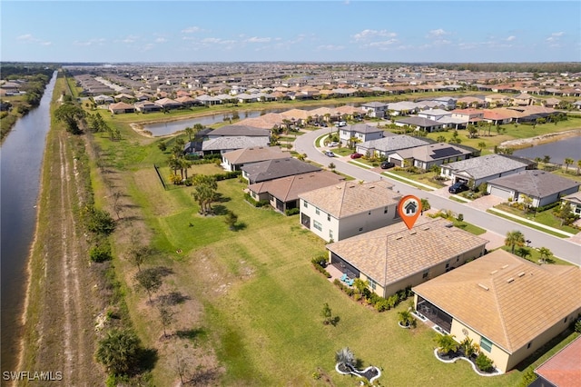 drone / aerial view featuring a water view and a residential view