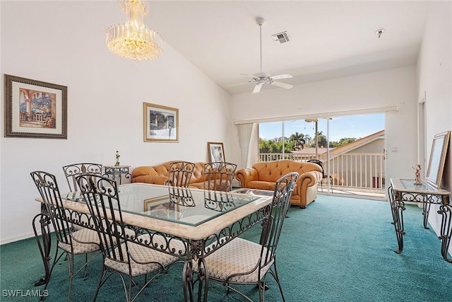 carpeted dining room featuring high vaulted ceiling, visible vents, baseboards, and ceiling fan with notable chandelier