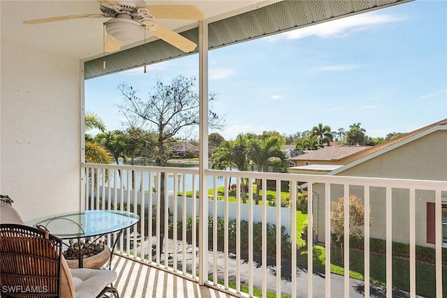 balcony with a water view and ceiling fan