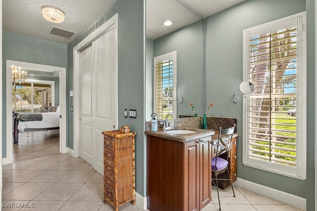 bar featuring plenty of natural light, light tile patterned flooring, a sink, and visible vents