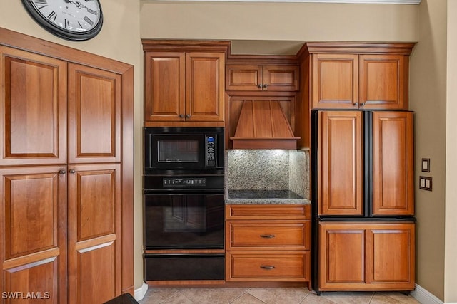 kitchen with black appliances, brown cabinetry, and a warming drawer