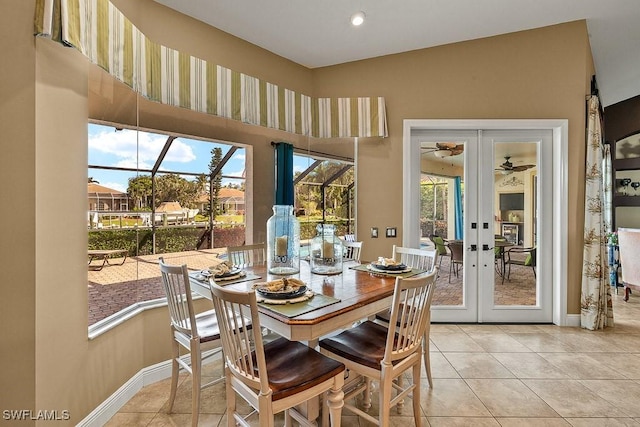 dining area featuring french doors, light tile patterned flooring, and baseboards