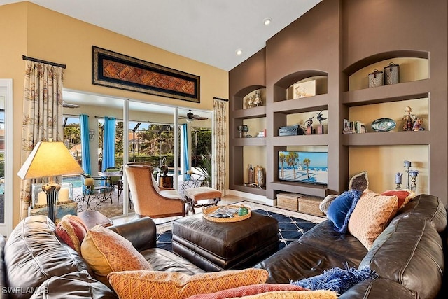 interior space featuring high vaulted ceiling and built in shelves