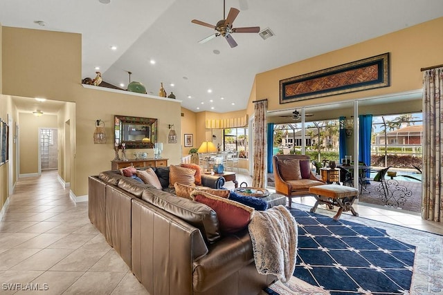 living room with a ceiling fan, a healthy amount of sunlight, visible vents, and light tile patterned floors