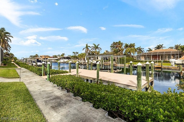 dock area featuring a water view, boat lift, and a residential view