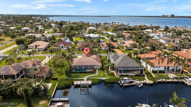 drone / aerial view with a water view and a residential view