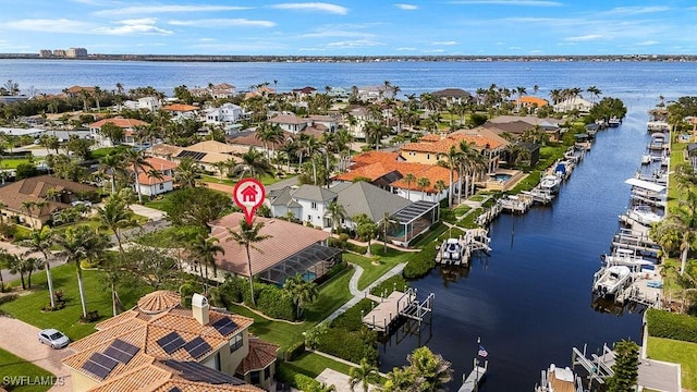 birds eye view of property with a water view and a residential view