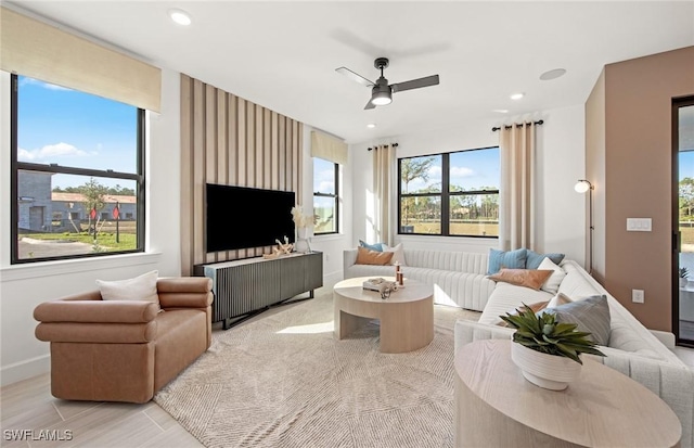 living area with ceiling fan, baseboards, and recessed lighting