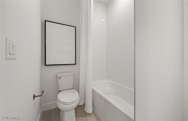 full bath featuring toilet, baseboards, shower / washtub combination, and wood finished floors