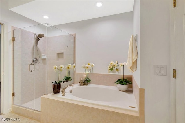 bathroom featuring a bath, recessed lighting, and a stall shower