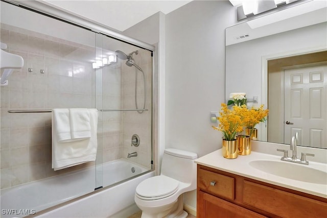 full bathroom featuring vanity, toilet, visible vents, and shower / bath combination with glass door