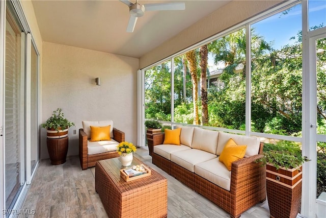 sunroom featuring a ceiling fan