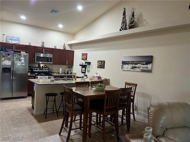 dining room featuring high vaulted ceiling, recessed lighting, visible vents, and light tile patterned floors