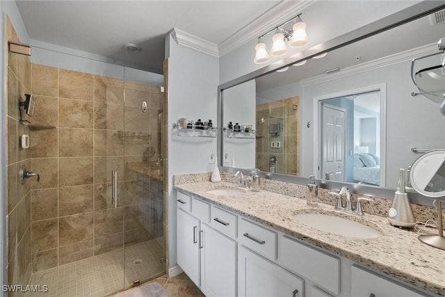 bathroom with ornamental molding, a sink, a shower stall, and double vanity