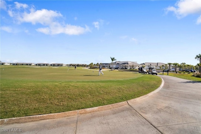 view of community with a residential view and a yard