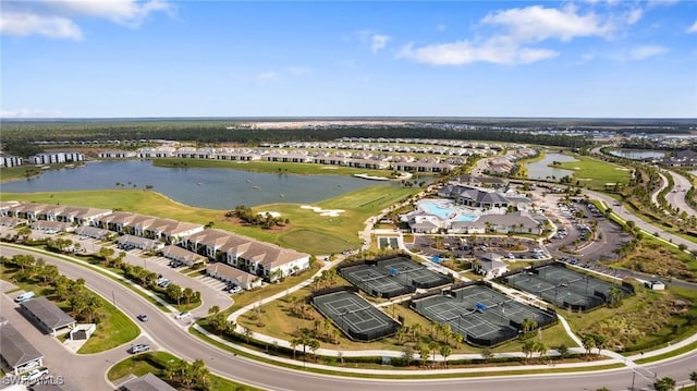 aerial view with a water view, view of golf course, and a residential view