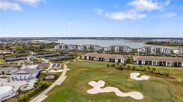 bird's eye view with view of golf course and a water view