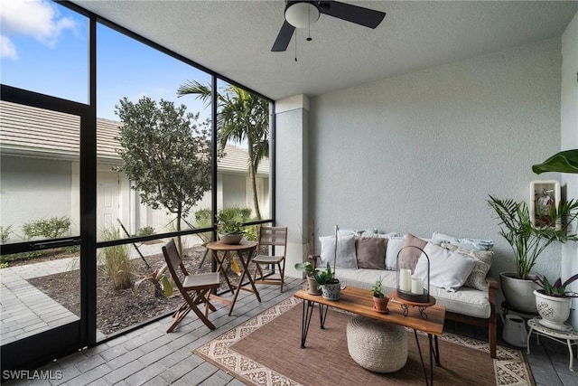 sunroom with a ceiling fan