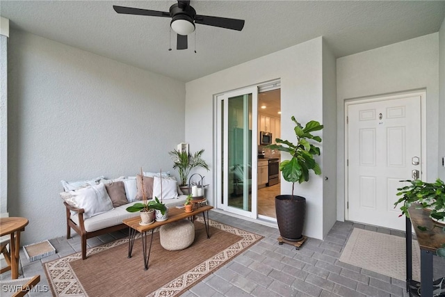 exterior space with a ceiling fan and outdoor lounge area