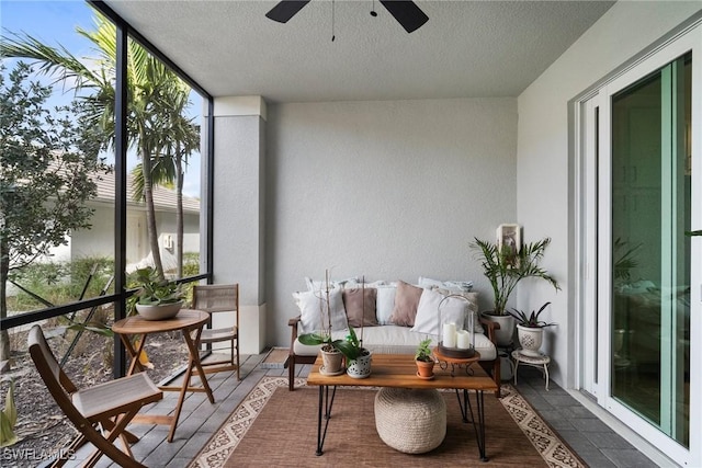 sunroom / solarium featuring ceiling fan