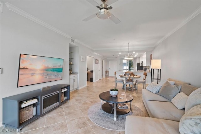 living area featuring light tile patterned flooring, a ceiling fan, visible vents, built in features, and crown molding