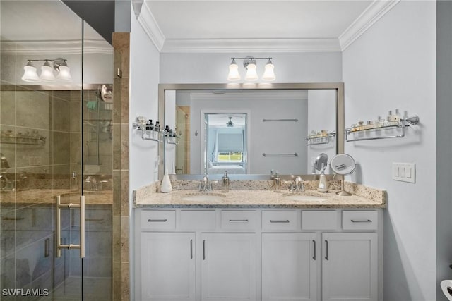 bathroom featuring a stall shower, crown molding, and a sink