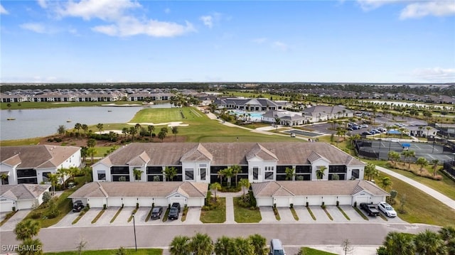 drone / aerial view featuring a residential view and a water view