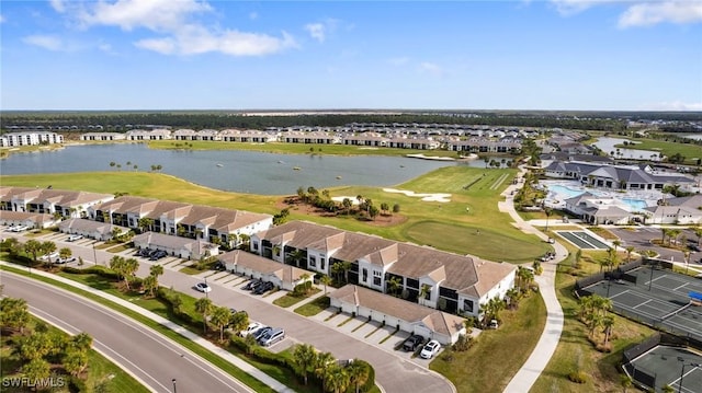 birds eye view of property with golf course view, a water view, and a residential view