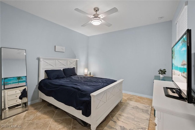 bedroom featuring light tile patterned flooring, ceiling fan, and baseboards