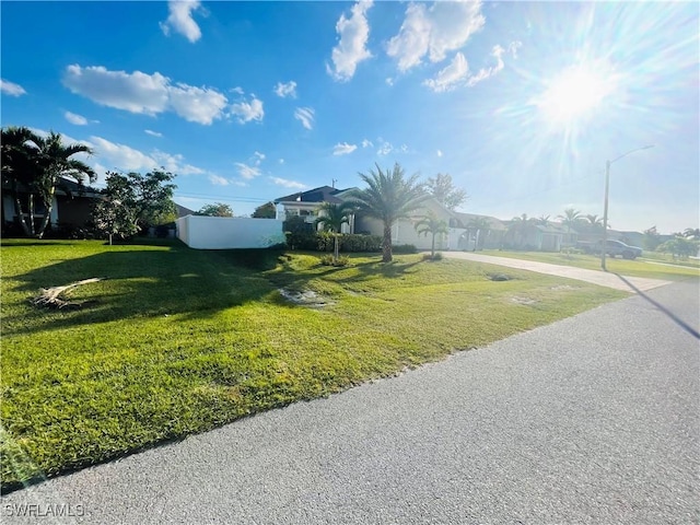 exterior space with a lawn and fence