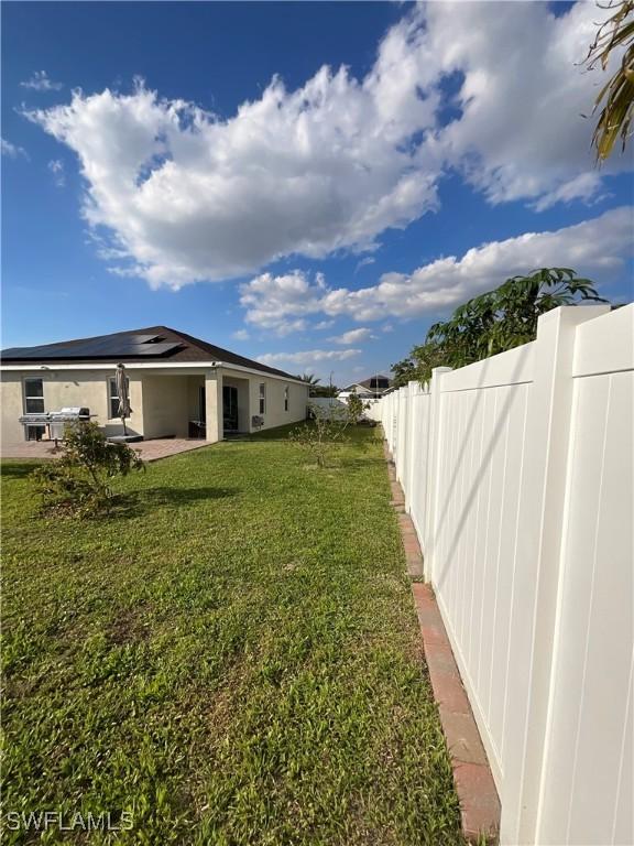 view of yard featuring a patio area and a fenced backyard