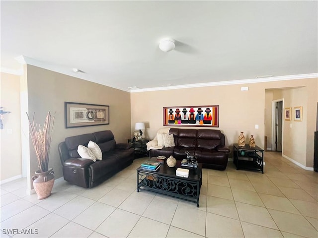 living area featuring baseboards, ornamental molding, and light tile patterned flooring