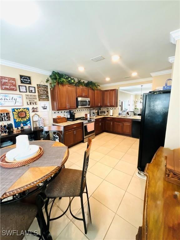 dining area featuring recessed lighting, visible vents, crown molding, and light tile patterned floors