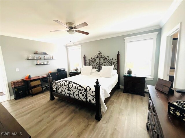 bedroom with light wood finished floors, ceiling fan, and ornamental molding