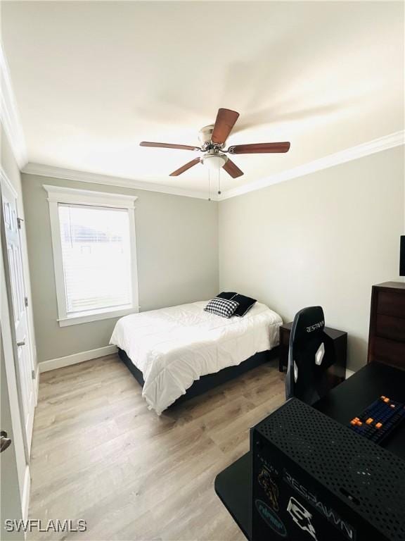 bedroom featuring baseboards, ornamental molding, a ceiling fan, and light wood-style floors