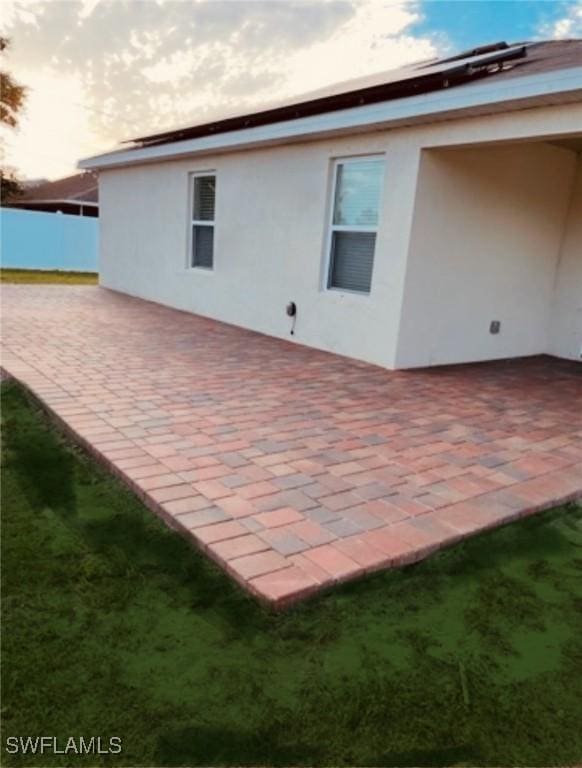 back of house with a patio, stucco siding, and fence