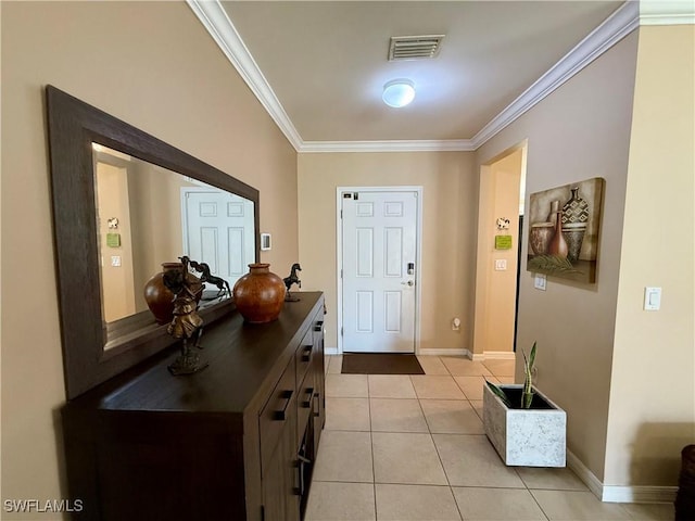 foyer featuring crown molding, visible vents, baseboards, and light tile patterned floors